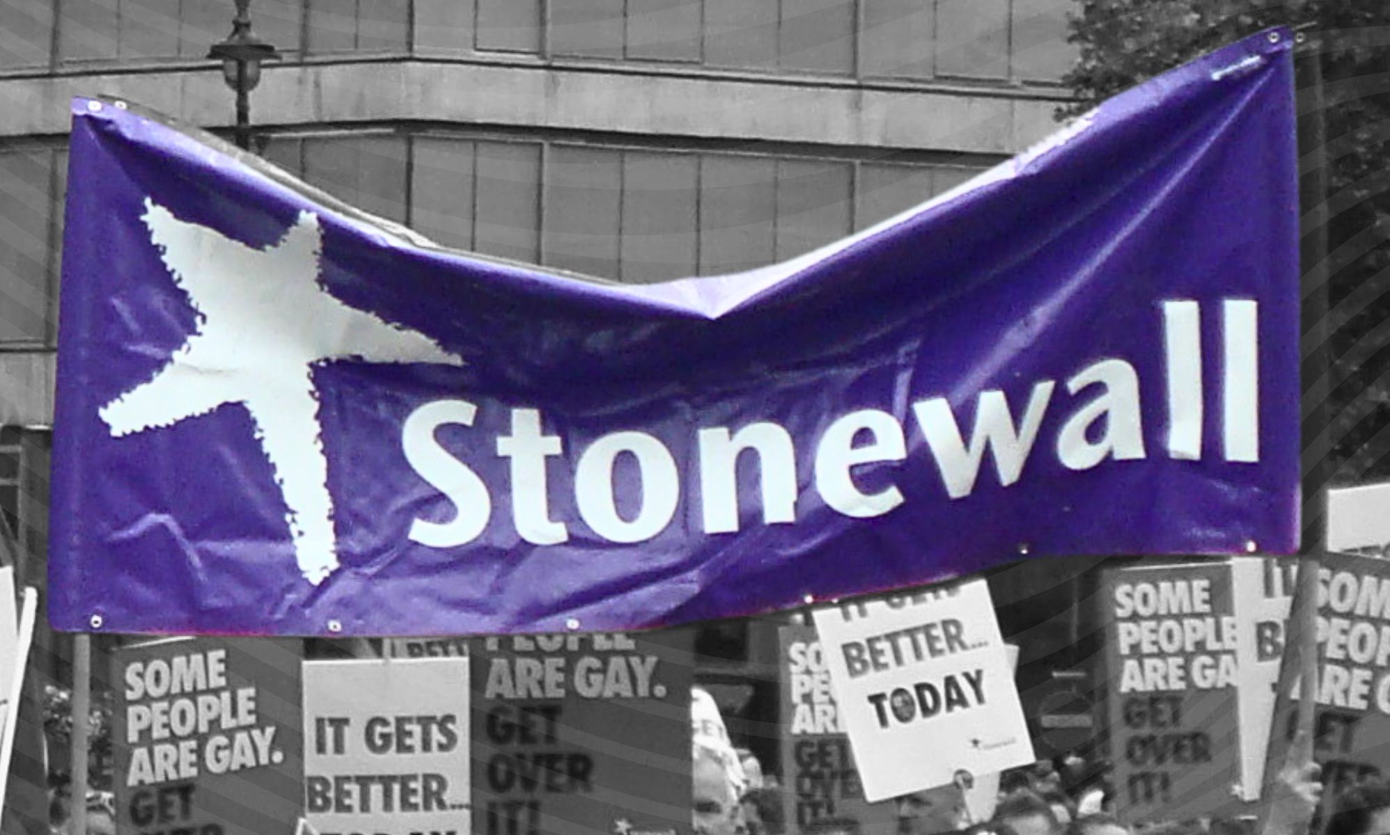 A Stonewall UK flag in a monochrome backdrop.